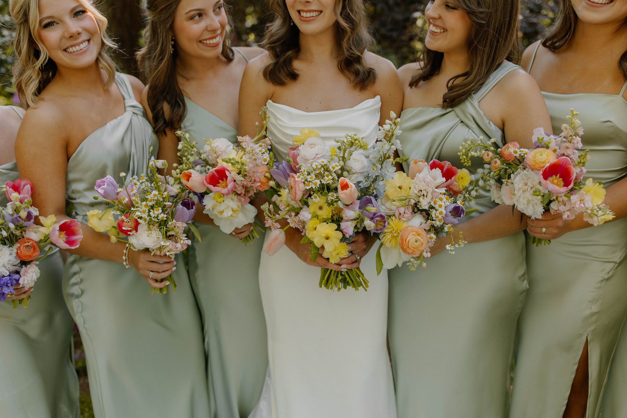 Bridesmaids with colorful floral bouquets at a South Carolina family property wedding