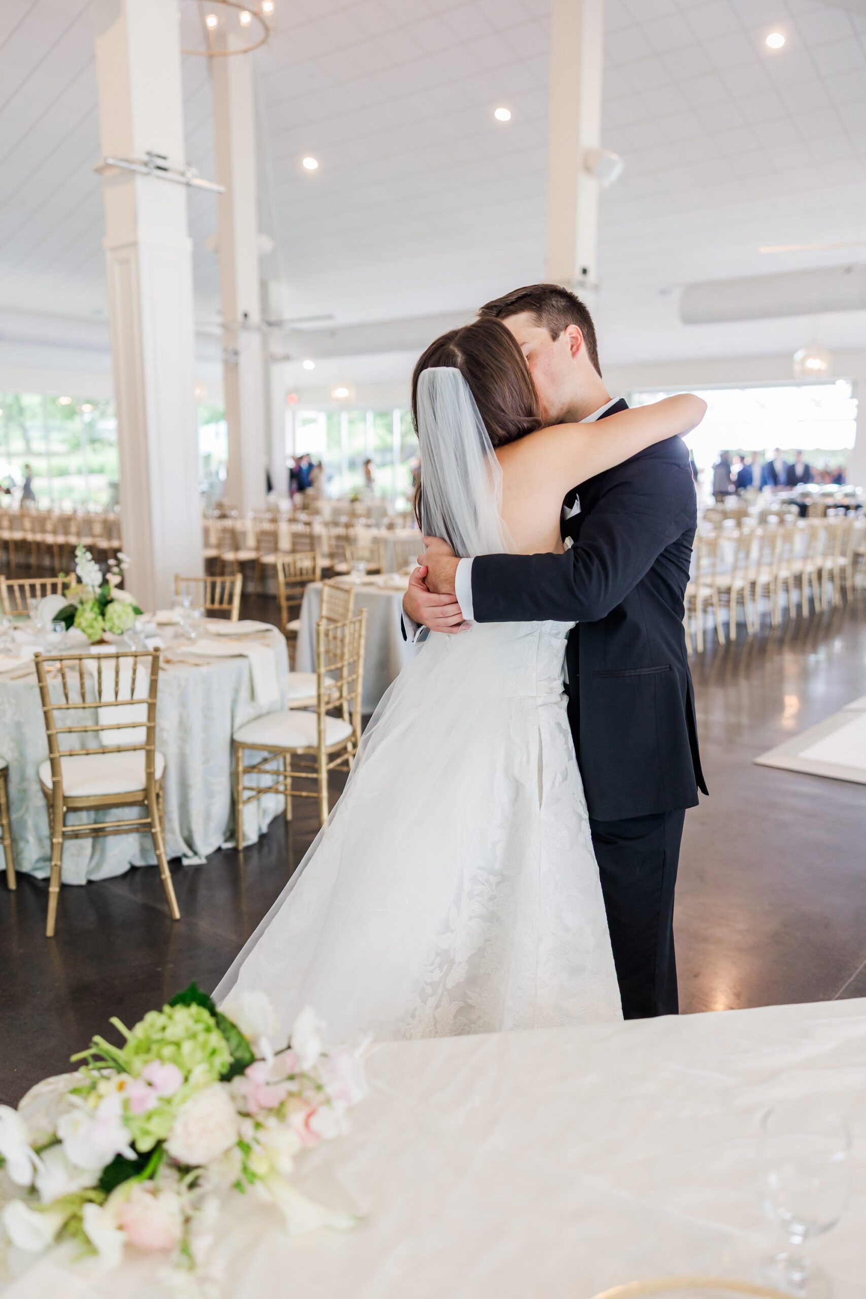 Couple sharing a romantic moment inside Owen Pavilion reception space